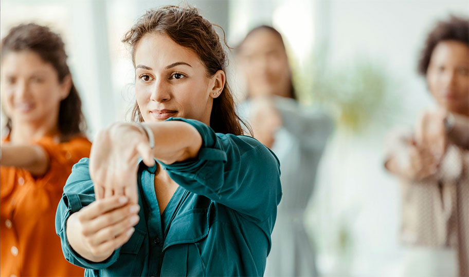 Women stretch in a wellness class